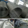 Custom stainless steel tubing coil unboxed with all accessories laid out on a flat surface, showing helical coil and fittings