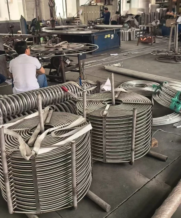 Custom-made stainless steel tubing coil in helical shape, side angle view showing coil diameter and tube dimensions